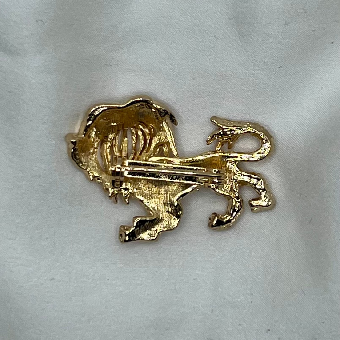 Gold lion-shaped brooch background